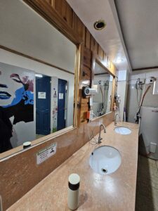 2面の大きな鏡と2台のヘアドライヤーがある共有バスルーム