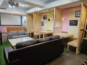 B5階の学生ラウンジに置かれた大きなソファーと木製テーブル
