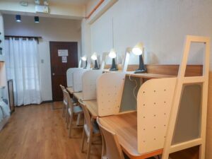 仕切り付きの勉強机が4台並んだスタジオタイプの4人部屋