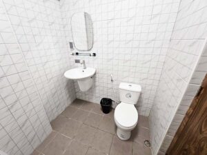 洗面台とトイレが設置されたタイル張りのバスルーム