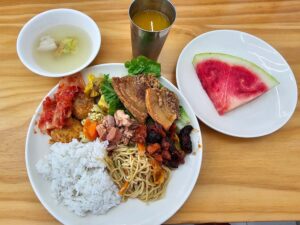 フィリピン料理のレチョンカワリ、焼きそば、イカの炒め物、スープの夕食
