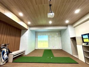 スクリーンとプロジェクターが設置されたVRゴルフ練習ルーム