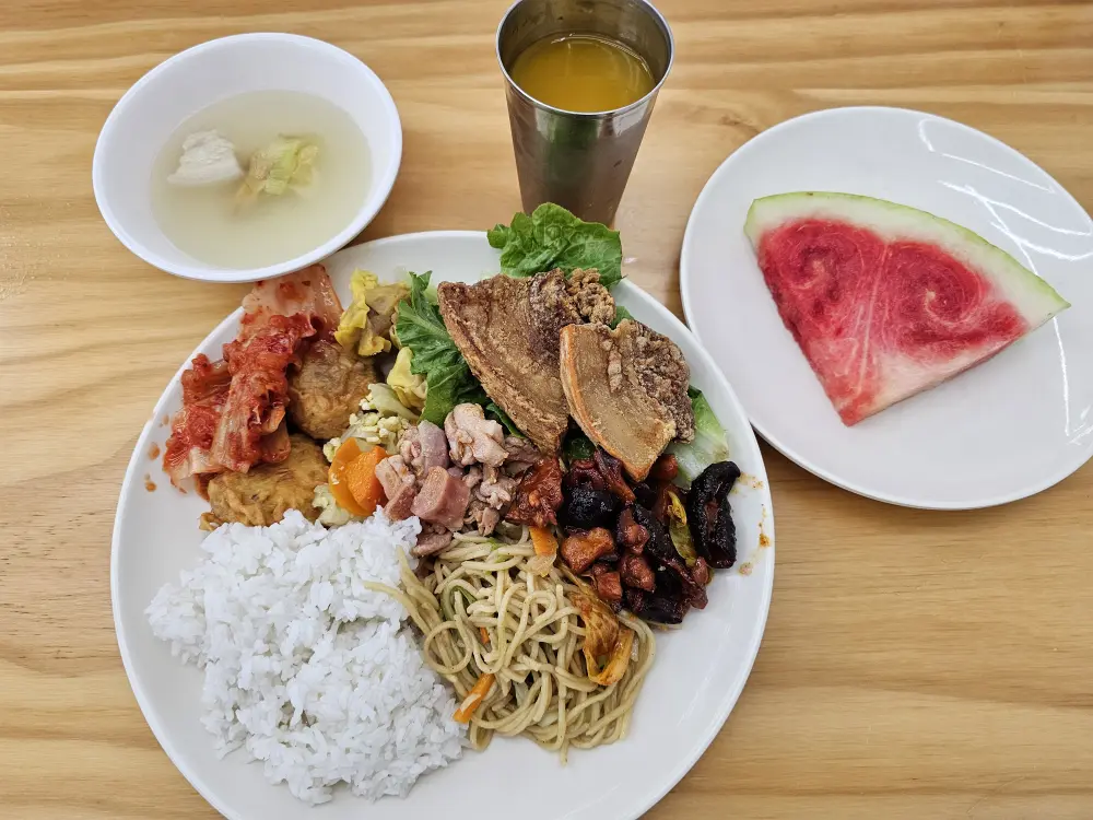 パスタ、キムチ、レチョンカワリ、サラダ、スイカ、スープが並んだ夕食