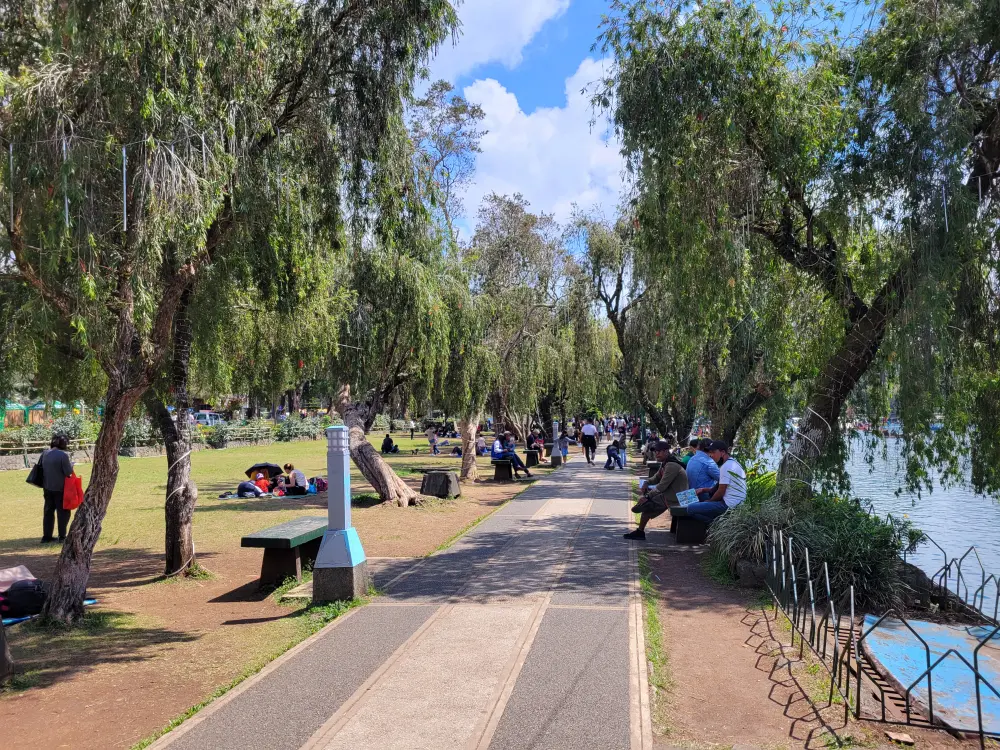 バギオのバーンハム公園でバミューダ芝生の周りに座る地元の人々