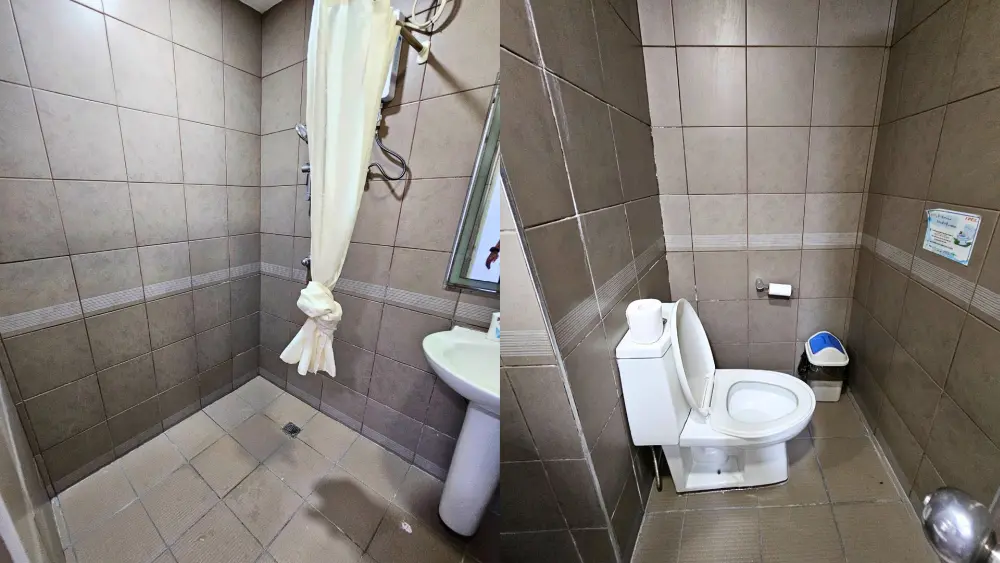 シャワーと洗面台、トイレが設置されたCPIのデラックスダブルルームのバスルーム