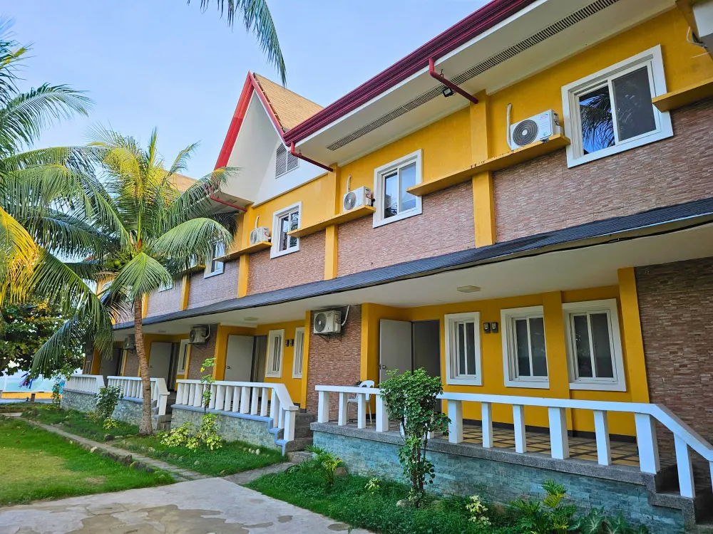 教室、学生寮、食堂が入るCIJ Academyメイン校舎の外観と校庭のヤシの木