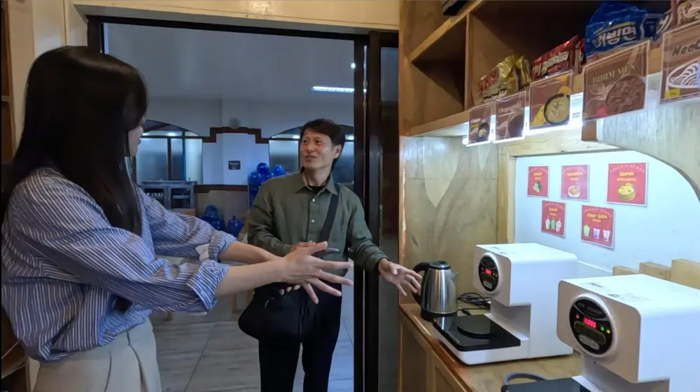 インスタントラーメンクッカーをGrit留学代表に説明しているAPI BECIの韓国人マネージャー