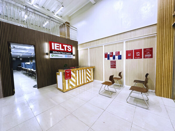 校舎1階にあるIELTS公式試験会場の看板と受付カウンター、待合用の椅子が設置された受付エリア