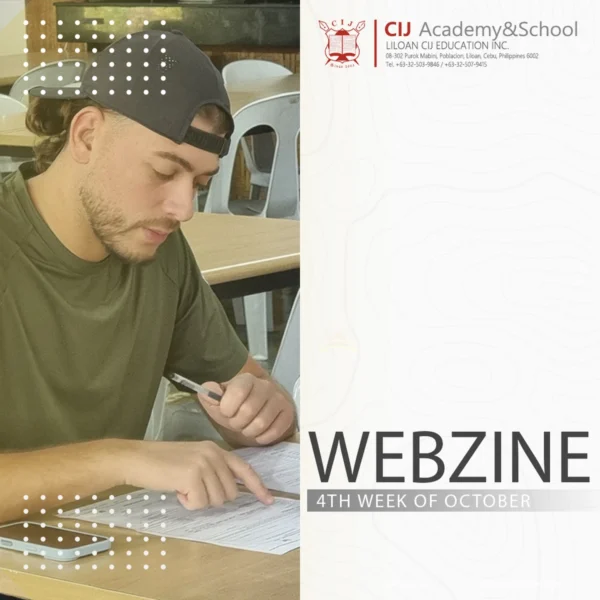 フィリピンのセブ島・リロアンにあるCIJ Academy & Schoolの2026年10月第4週Webzineの表紙で、黒いキャップをかぶった男性学生が机に向かい、ペンを持ちながら学習資料を確認している写真